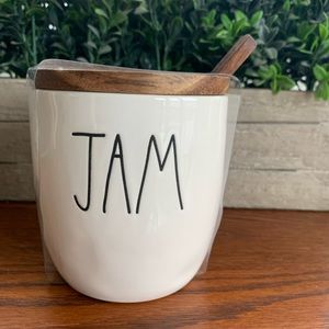 Rae Dunn Jam jar with wooden lid and wooden spoon.